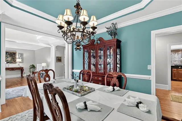 a living room with furniture a fireplace and a chandelier