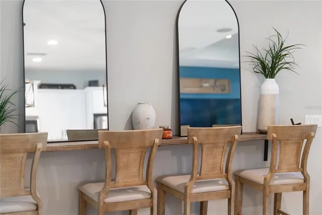 a kitchen with granite countertop a refrigerator and wooden floor