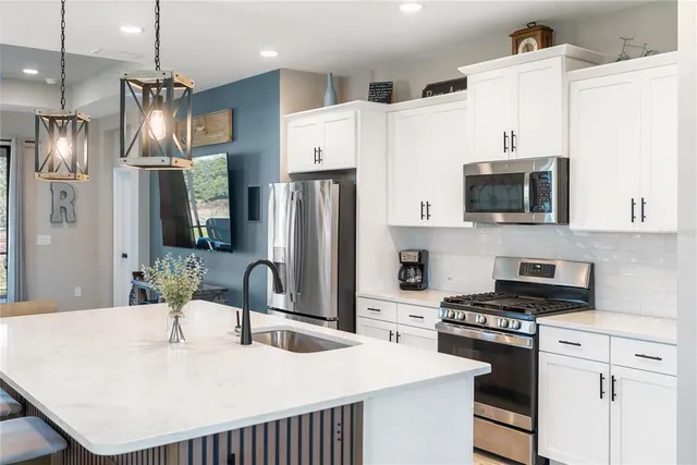 a view of a livingroom with wooden floor and furniture