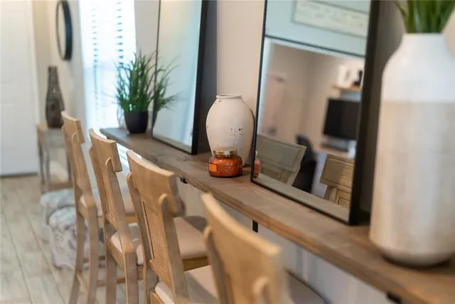 a kitchen with stainless steel appliances kitchen island granite countertop a stove a sink dishwasher and a refrigerator with wooden floor