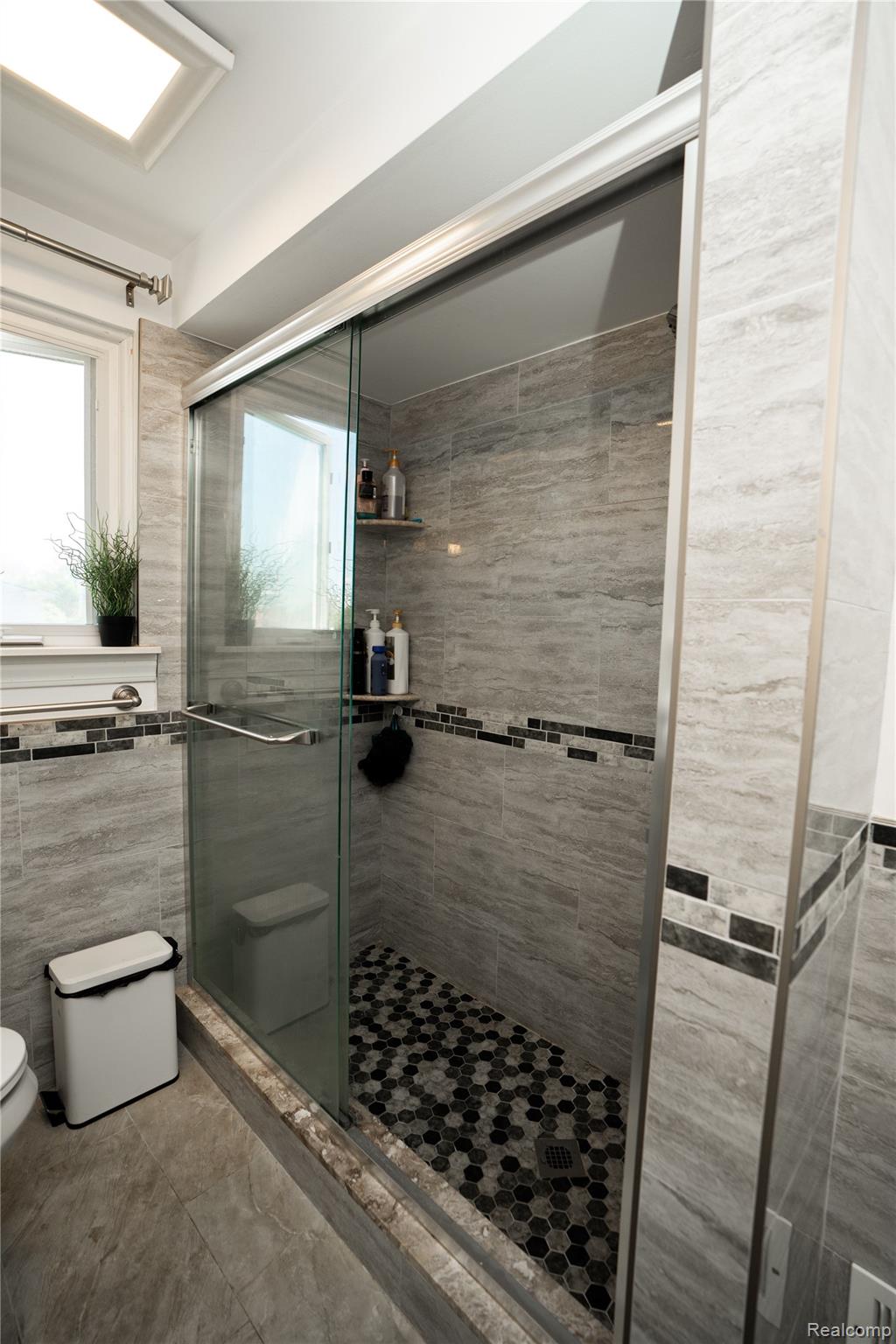 3131 Elmcrest Road Sterling Heights, MI 48310 - Photo 24 of 46 Full bath with a stall shower and tile walls