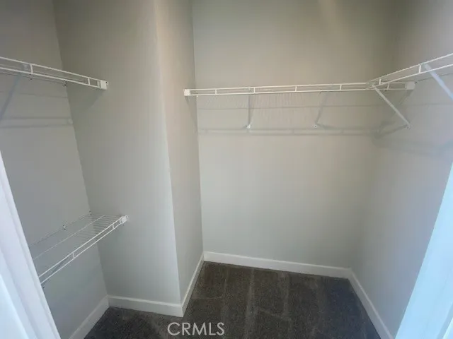 a white toilet sitting in a bathroom next to a window