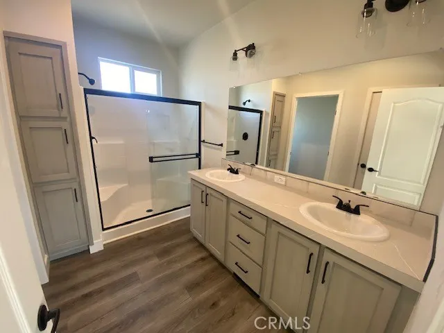 a bathroom with double vanity sink and mirror