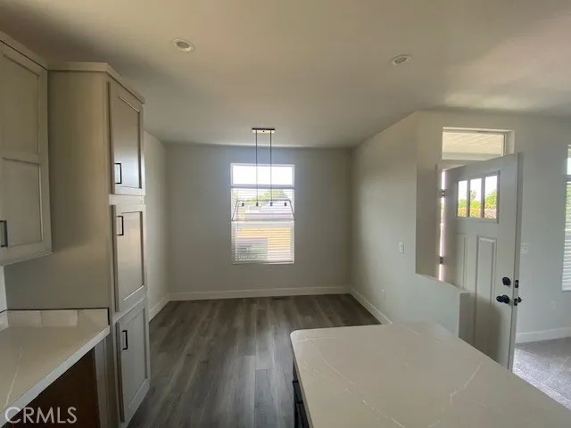 a view of a livingroom with wooden floor and windows