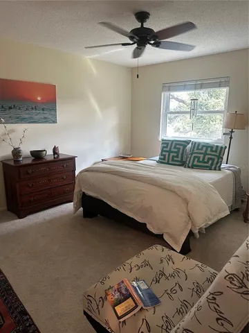 a bedroom with a bed dresser and a window