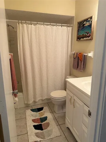 a bathroom with a toilet and a shower curtain