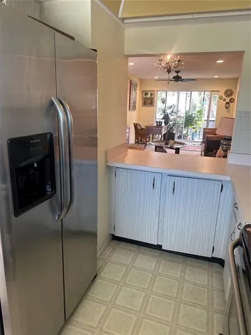 a kitchen with kitchen island granite countertop cabinets and stainless steel appliances