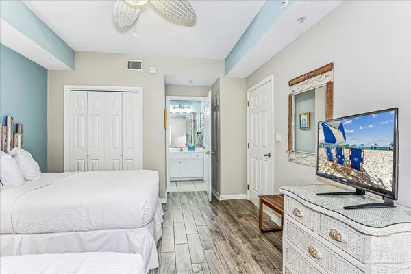 a bedroom with a bed and a flat screen tv