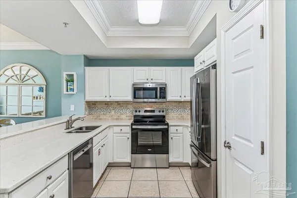 a kitchen with stainless steel appliances granite countertop a stove and a refrigerator