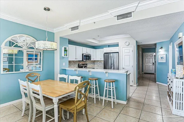 a view of a dining room with furniture and a chandelier
