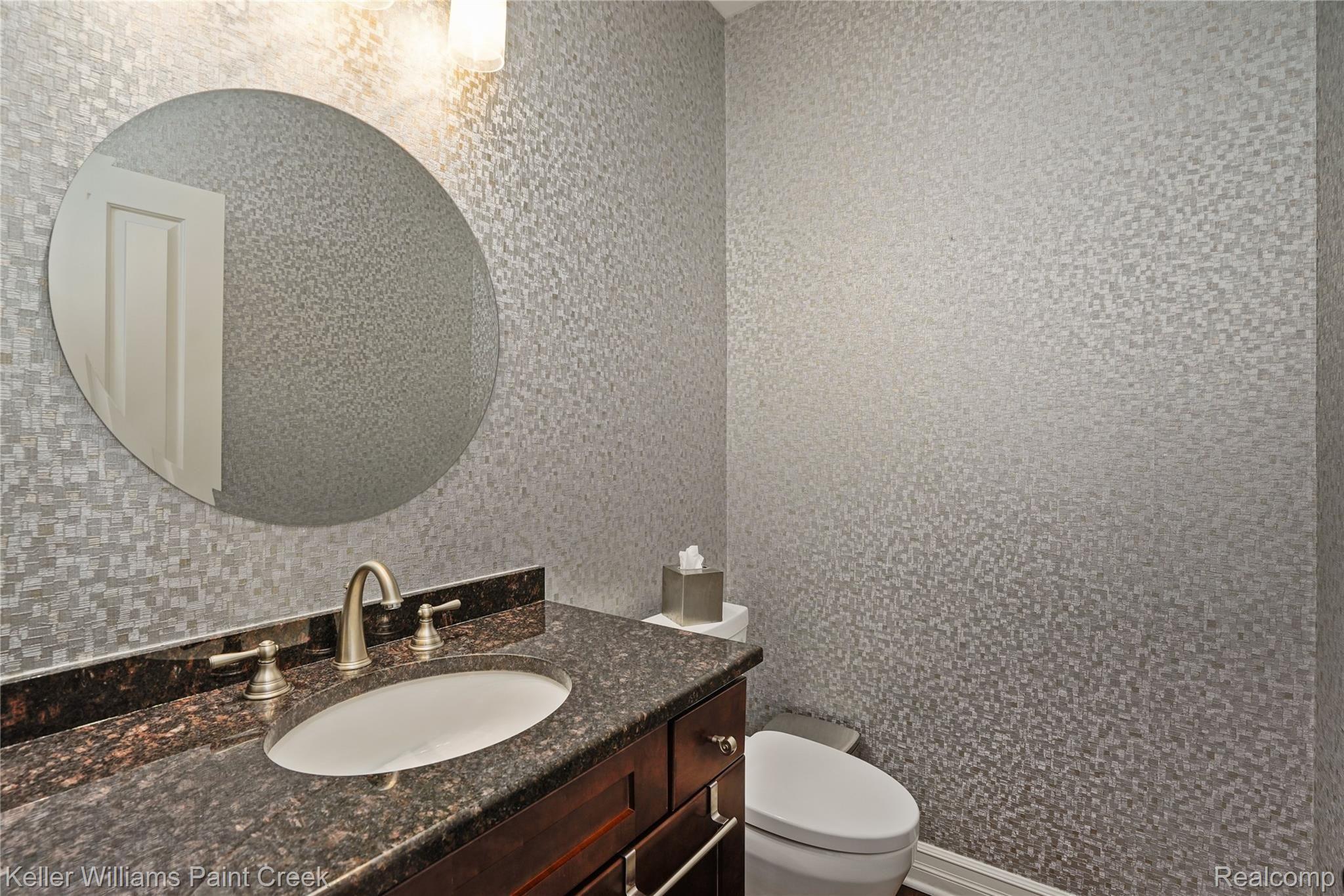 309 West 2nd Street Rochester, MI 48307 - Photo 6 of 19 Main level lavatory offers updated decor and a large granite vanity.