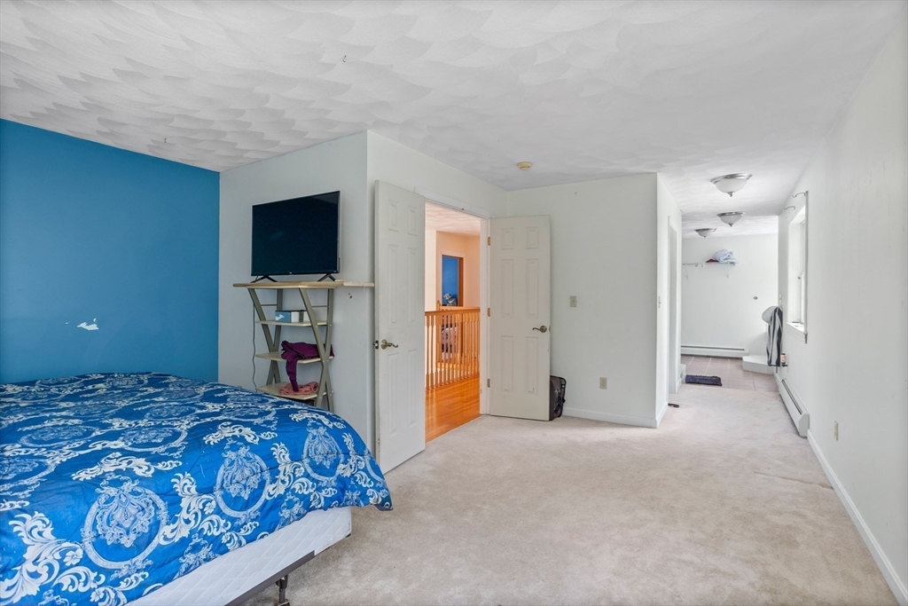 85 Wheeler Road Princeton, MA 01541 - Photo 12 of 28 a bedroom with a bed and a flat screen tv