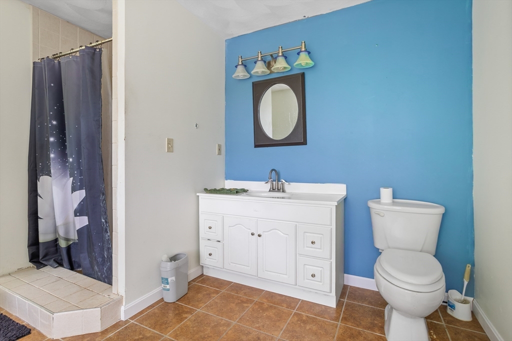 85 Wheeler Road Princeton, MA 01541 - Photo 14 of 28 a bathroom with a toilet sink vanity and mirror