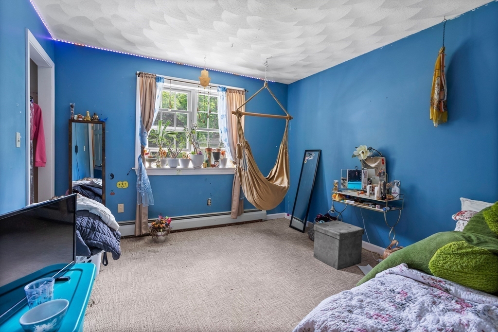 85 Wheeler Road Princeton, MA 01541 - Photo 15 of 28 a living room with furniture gym equipment and a window