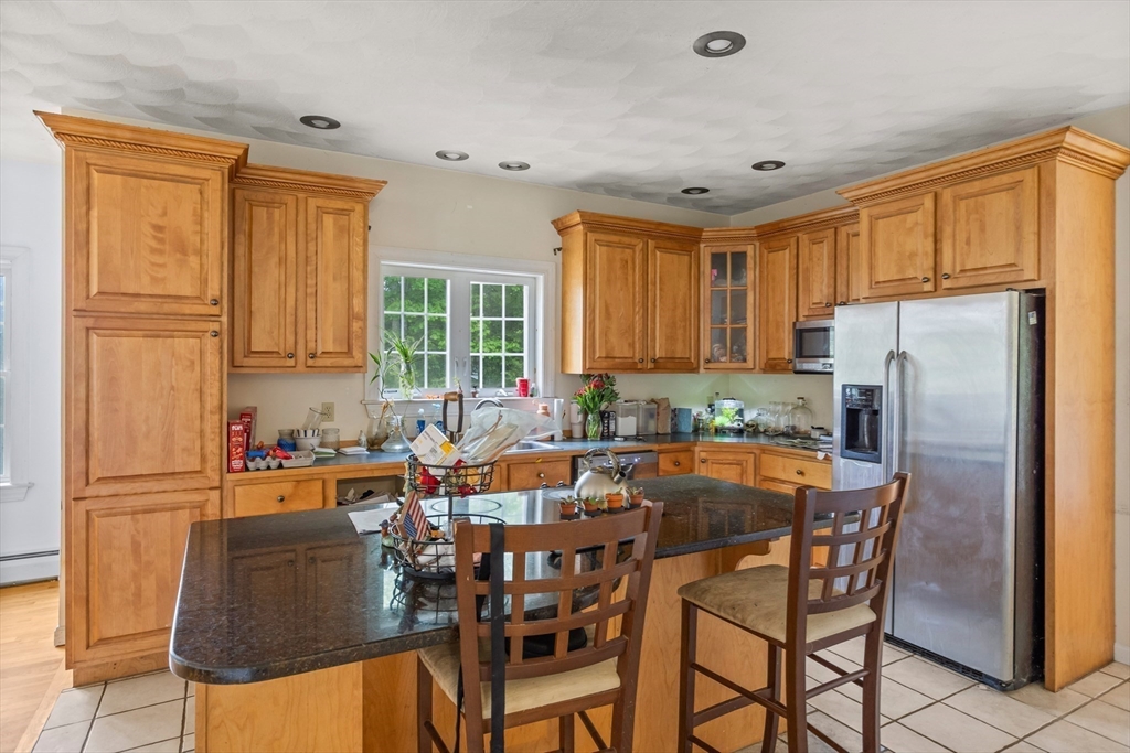 85 Wheeler Road Princeton, MA 01541 - Photo 5 of 28 a table and chairs in a kitchen with a window