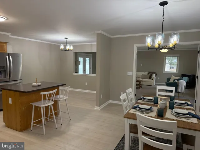 a view of a dining room with furniture and chandelier
