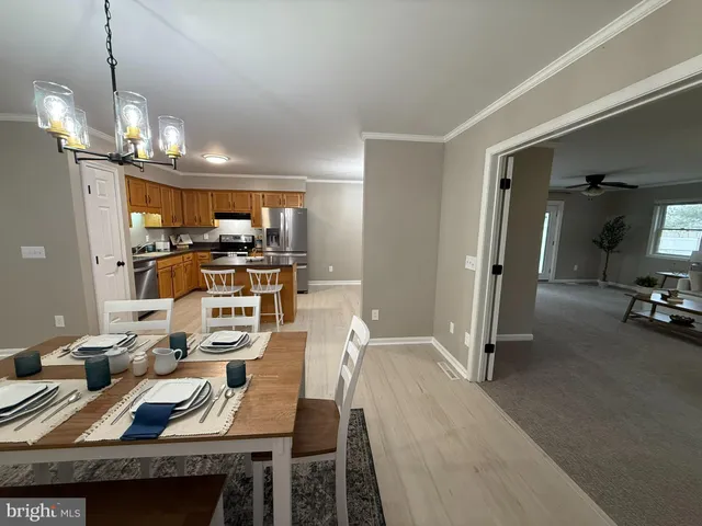 a view of a dining room with furniture and a chandelier