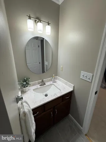 a bathroom with a sink vanity and a mirror