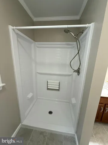 a bathroom with a glass shower door