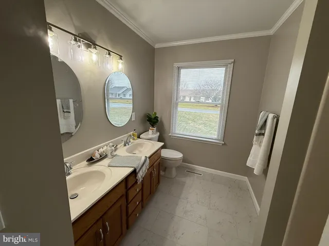 a bathroom with a double vanity sink and a mirror