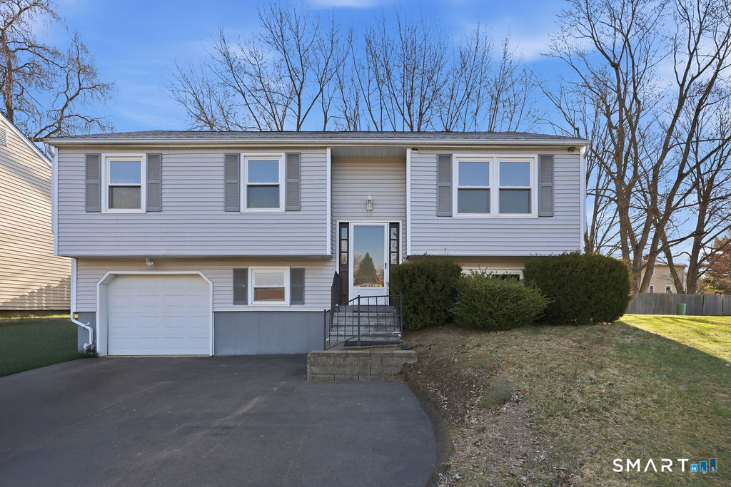 20 Kent Court Middletown, CT 06457 - Photo 1 of 1 a front view of a house with a yard and garage