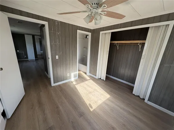 a view of hallway with wooden floor