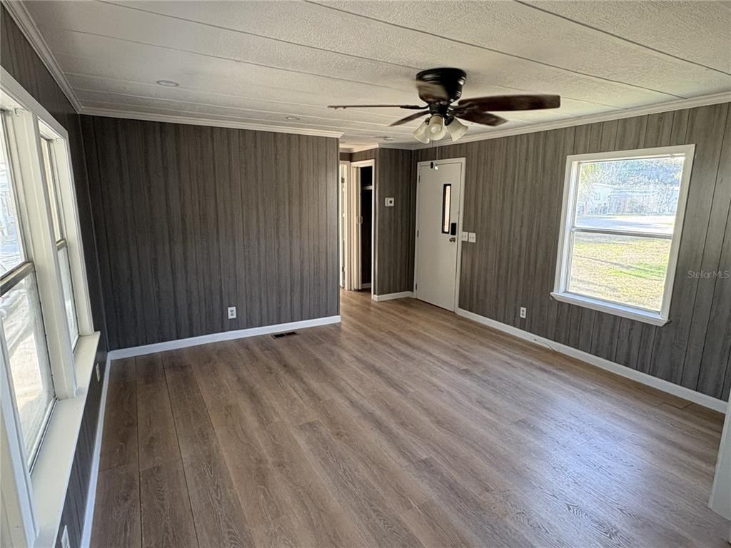 1183 9th Street Okeechobee, FL 34974 - Photo 7 of 14 a view of an empty room with wooden floor and a window