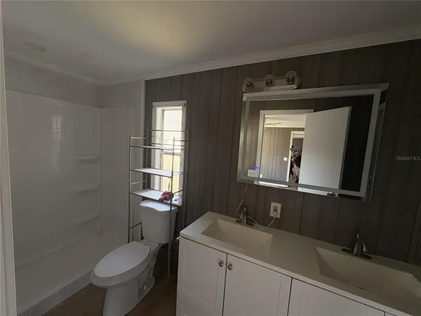 a bathroom with a sink a toilet and a mirror