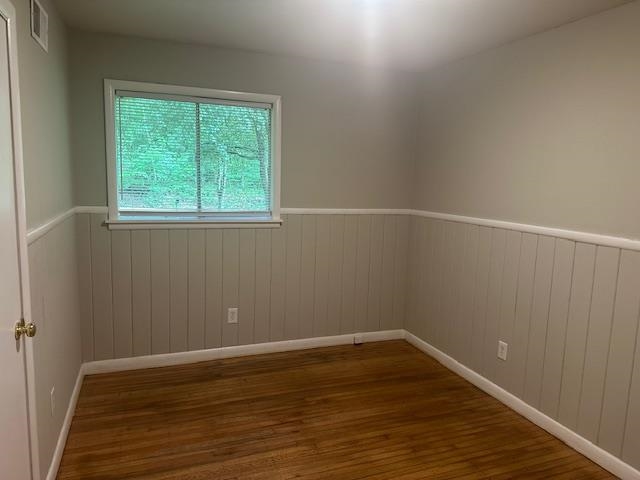 1406 Sycamore Road Collierville, TN 38017 - Photo 5 of 6 Empty room with baseboards, wainscoting, wood finished floors, and visible vents