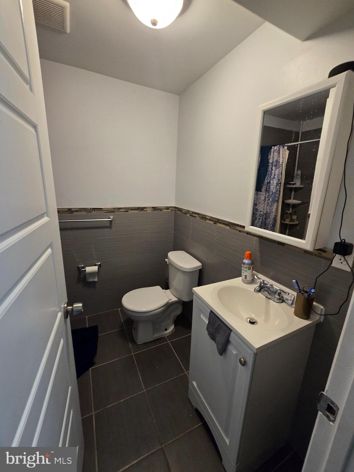 1833 Master Street Philadelphia, PA 19121 - Photo 19 of 22 a bathroom with a sink a toilet and a mirror