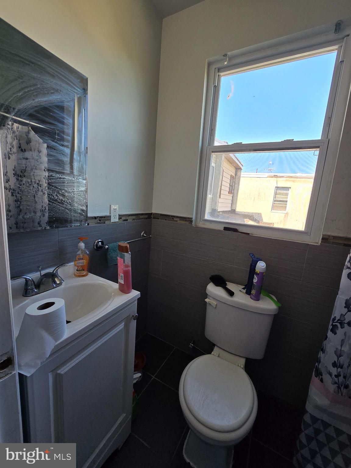 1833 Master Street Philadelphia, PA 19121 - Photo 9 of 22 a bathroom with a toilet sink and mirror