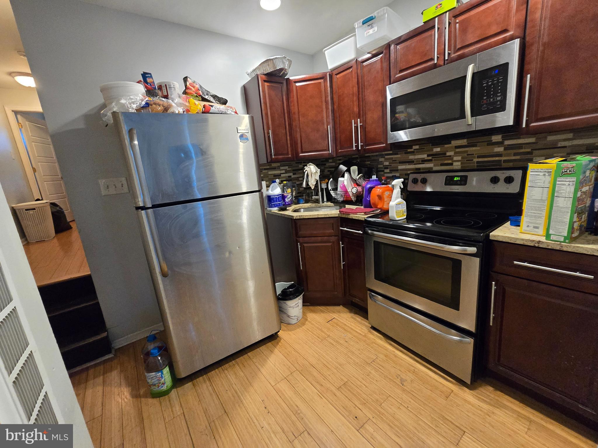 1833 Master Street Philadelphia, PA 19121 - Photo 10 of 22 a kitchen with stainless steel appliances a stove a microwave and a refrigerator