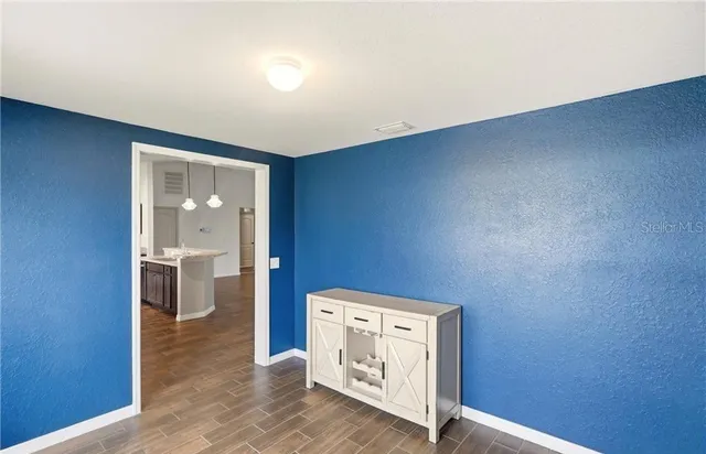 a view of a hallway with a white walls and a window