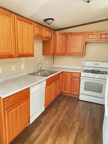 5003 Beacon Ridge Lowell, IN 46356 - Photo 2 of 18 a kitchen with a sink stove and cabinets