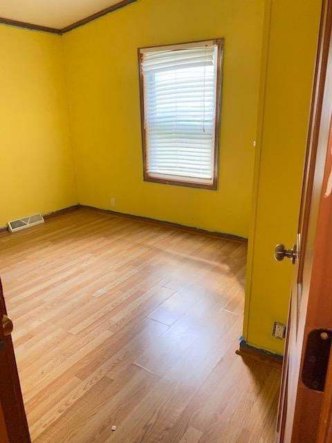 5003 Beacon Ridge Lowell, IN 46356 - Photo 7 of 18 an empty room with wooden floor and a window