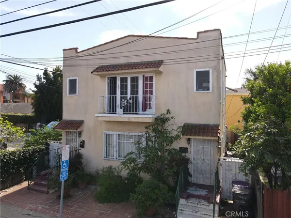 a view of a house with a small yard and plants