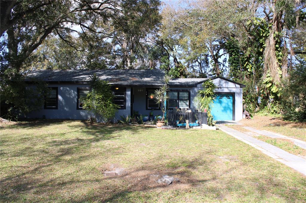 a front view of a house with a garden
