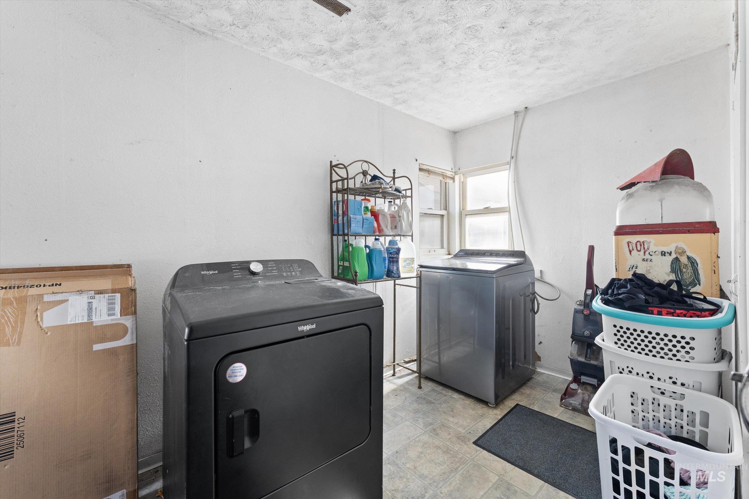 20286 Travis Road Wilder, ID 83676 - Photo 13 of 48 Laundry room featuring separate washer and dryer and a textured ceiling