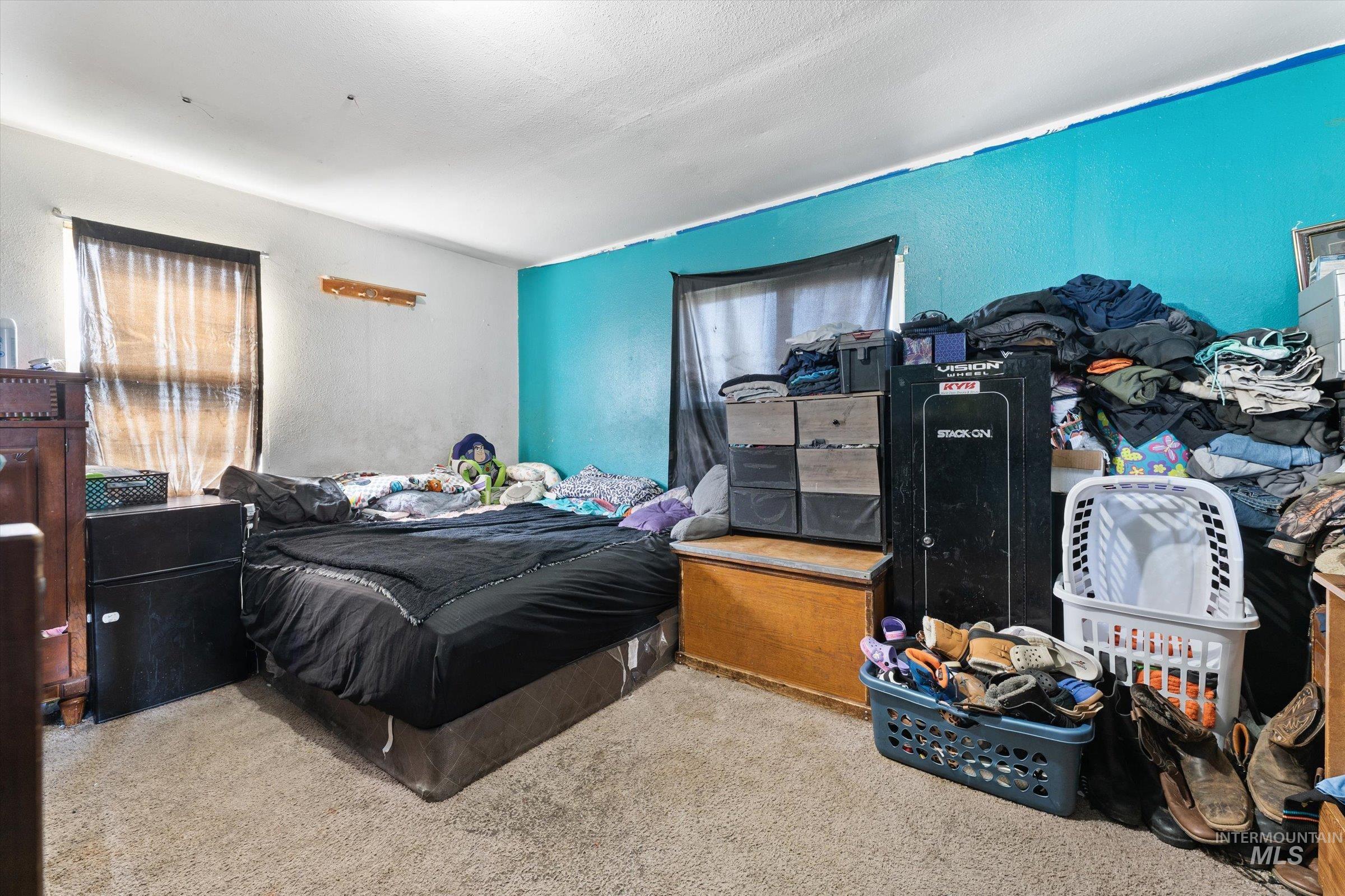 20286 Travis Road Wilder, ID 83676 - Photo 20 of 48 Carpeted bedroom with a textured wall
