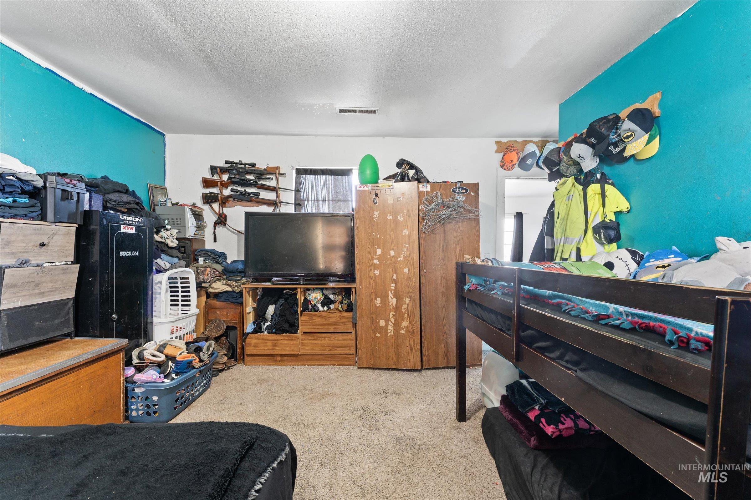 20286 Travis Road Wilder, ID 83676 - Photo 21 of 48 Bedroom featuring light colored carpet and a textured ceiling