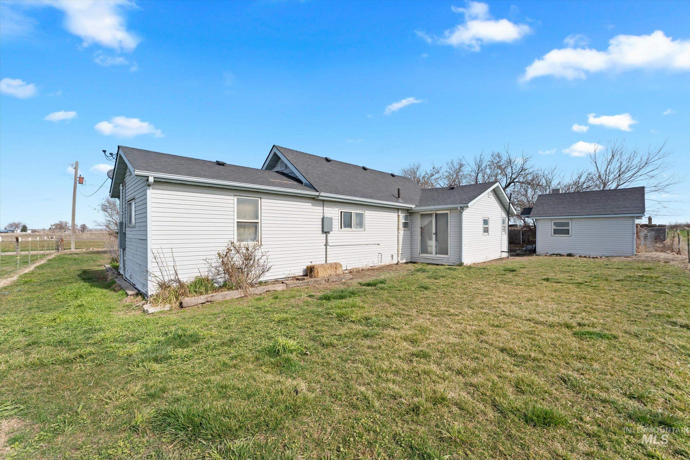 20286 Travis Road Wilder, ID 83676 - Photo 24 of 48 Back of house featuring an outbuilding