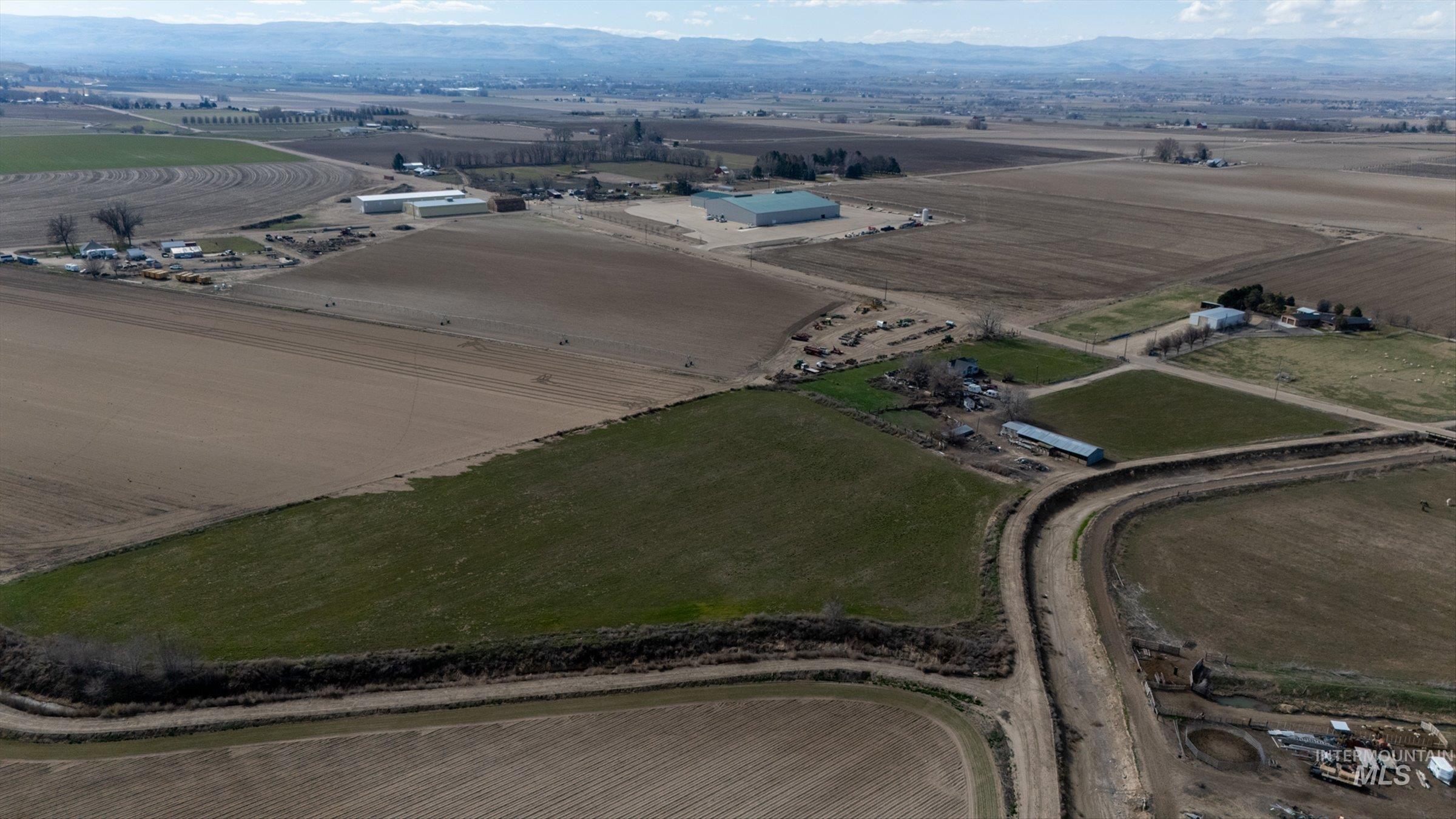 20286 Travis Road Wilder, ID 83676 - Photo 45 of 48 Aerial overview of property's location featuring rural landscape, abundant farmland, and a mountain backdrop