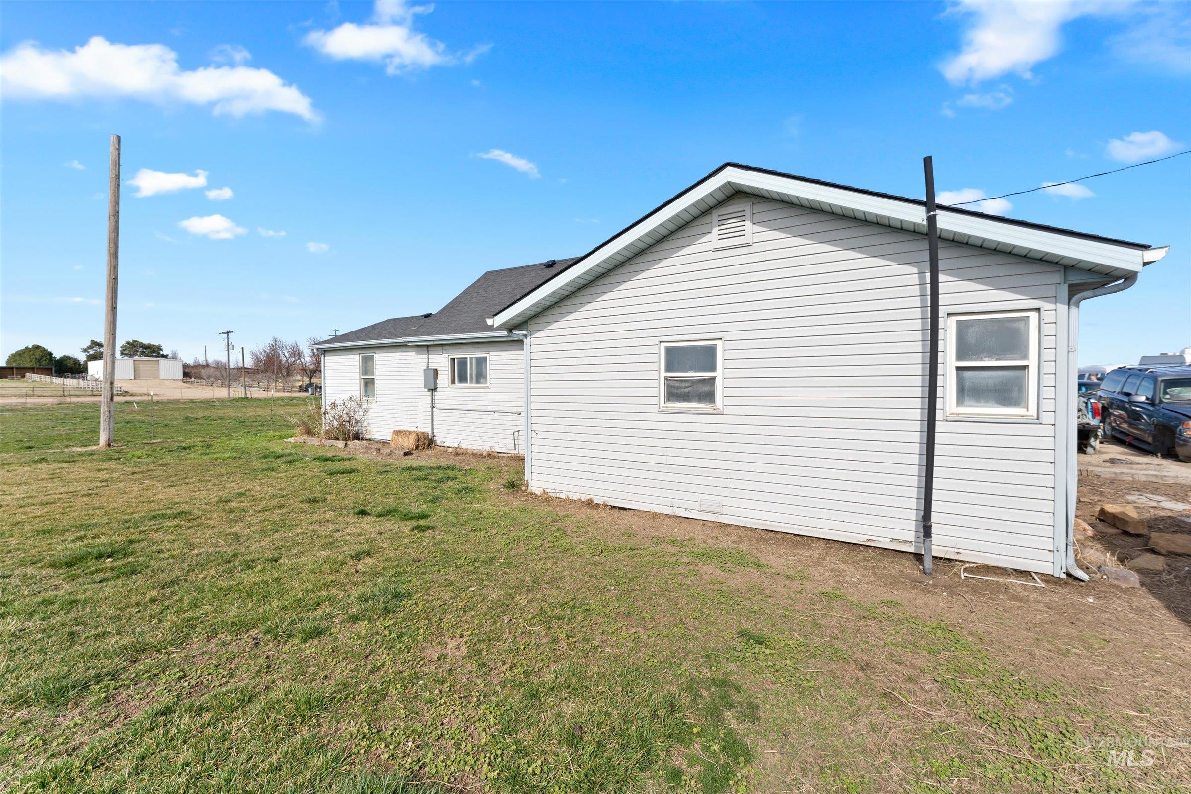 20286 Travis Road Wilder, ID 83676 - Photo 5 of 48 View of side of home with a yard