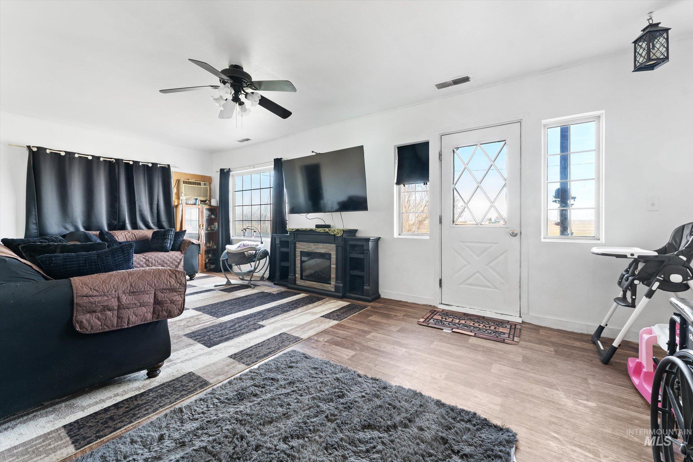 20286 Travis Road Wilder, ID 83676 - Photo 6 of 48 Living room featuring light wood-type flooring and ceiling fan