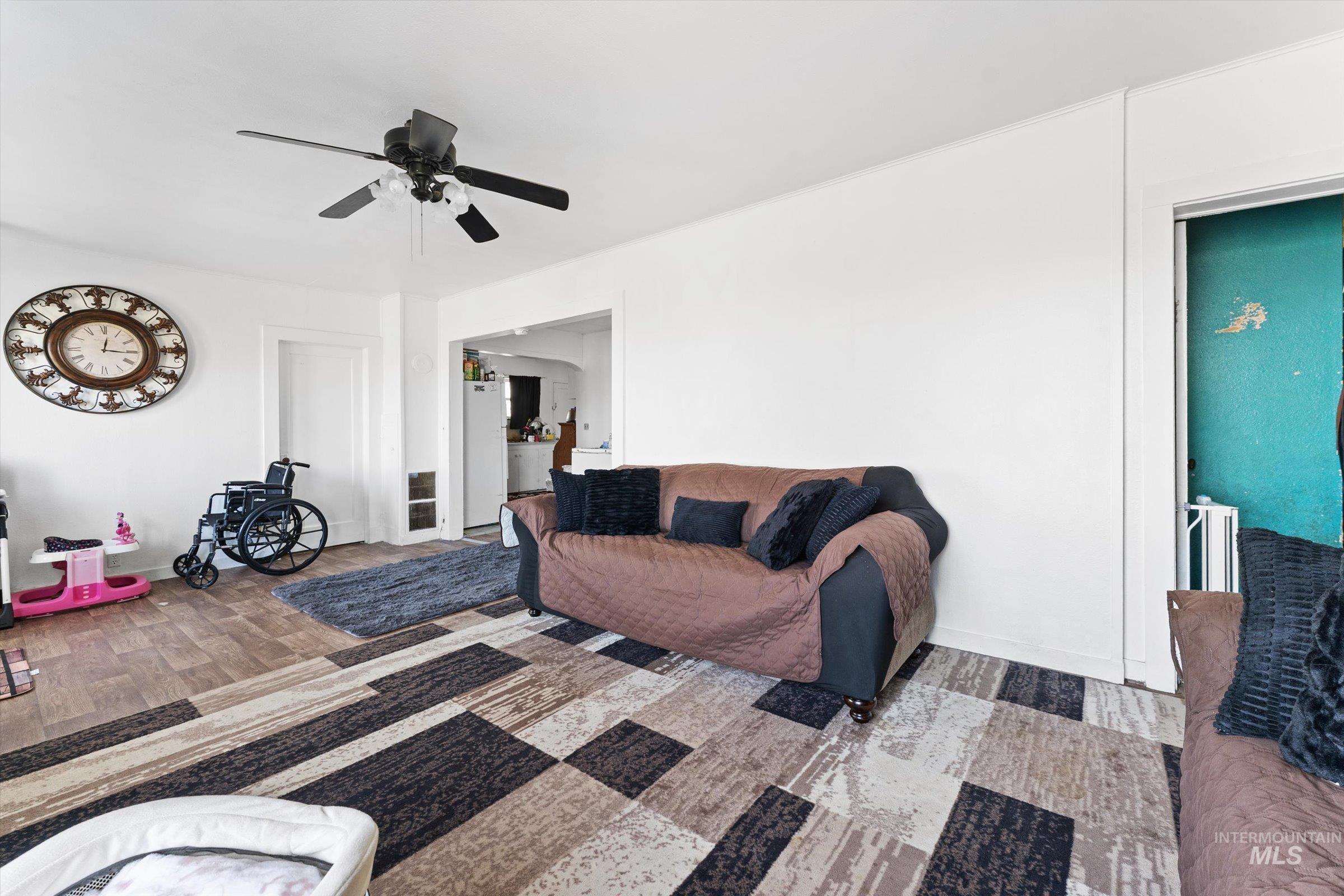 20286 Travis Road Wilder, ID 83676 - Photo 7 of 48 Living room featuring ceiling fan and light wood-style flooring