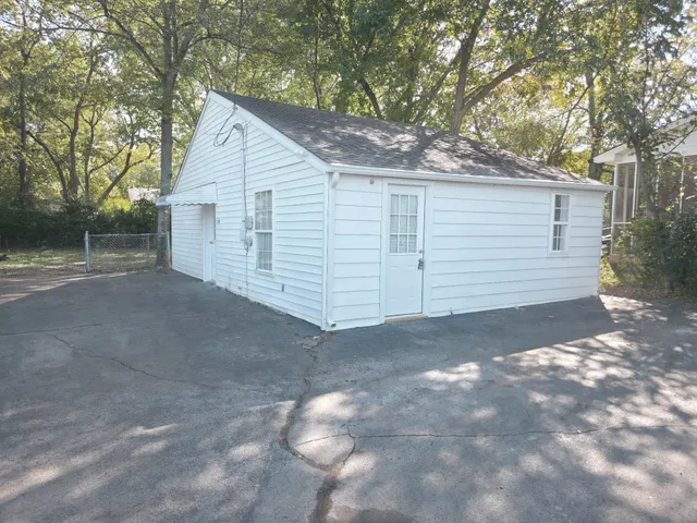 a view of a house with a yard and garage