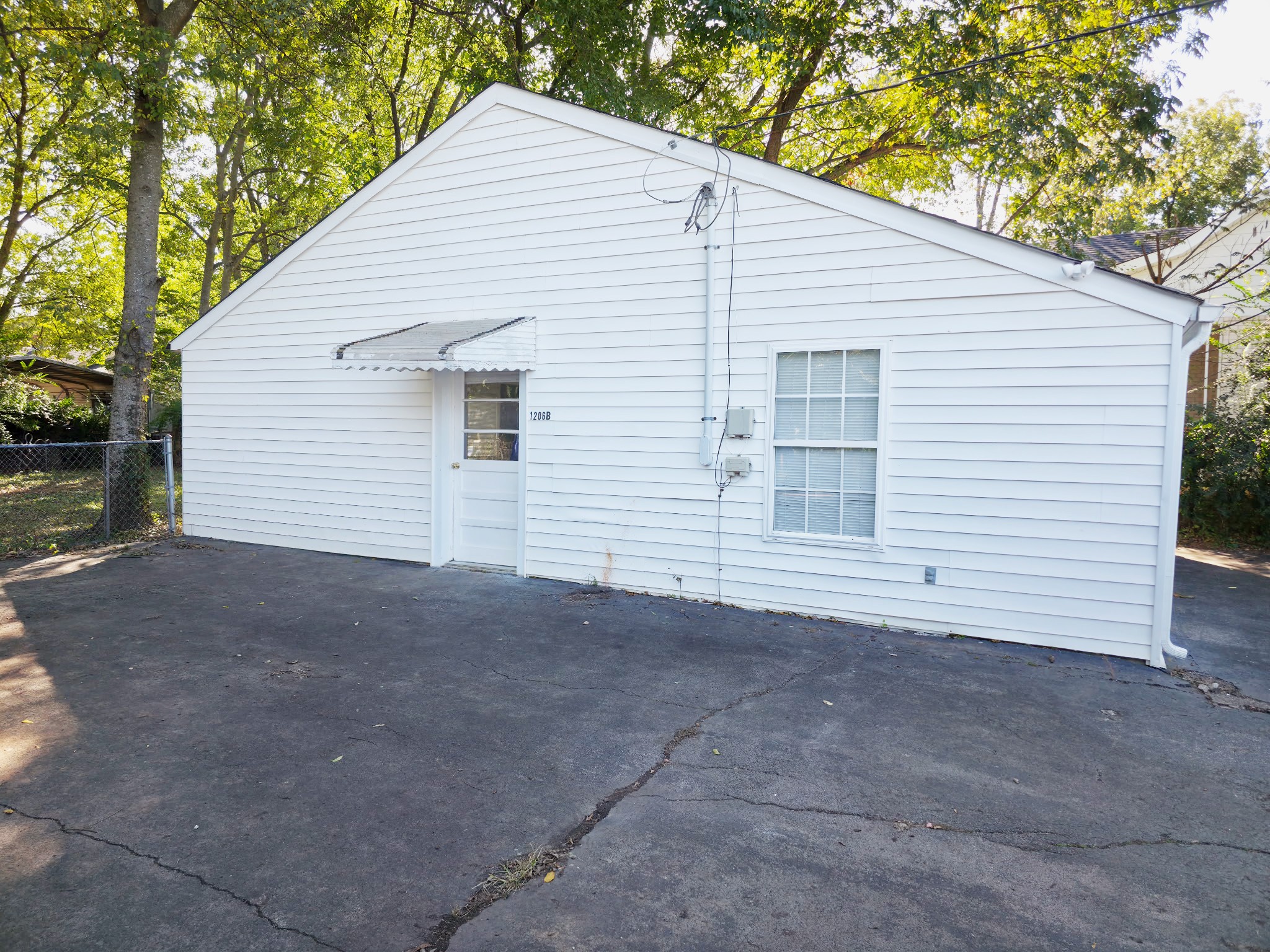 1206 North Church Street, Unit B Murfreesboro, TN 37130 - Photo 2 of 13 a view of a house with a yard and garage