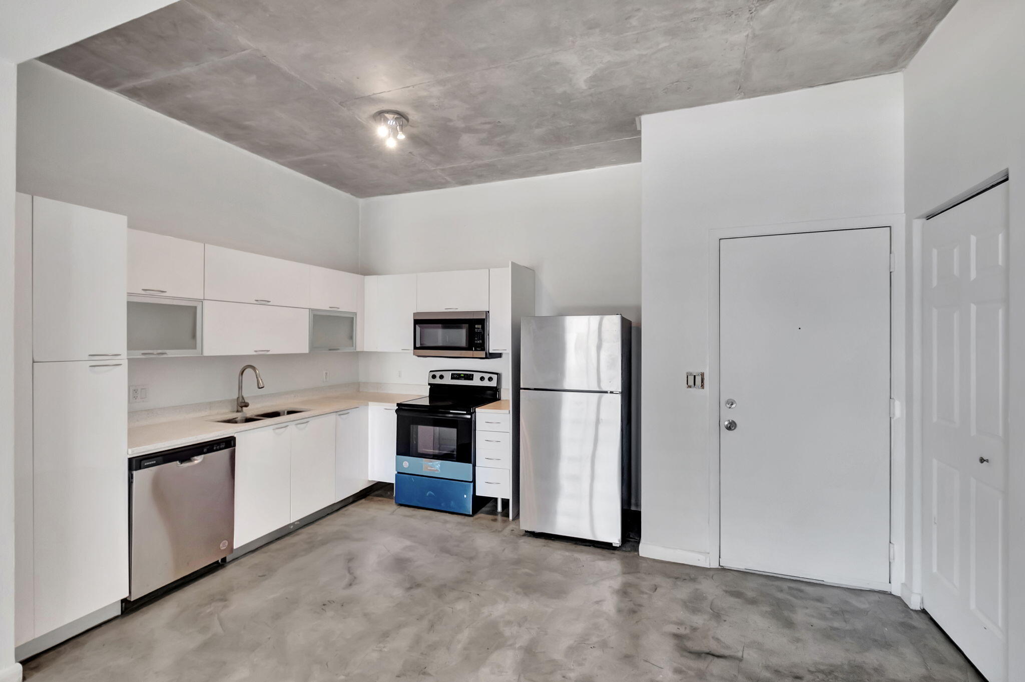 234 Northeast 3rd Street, Unit 2206 Miami, FL 33132 - Photo 13 of 30 a kitchen with stainless steel appliances a refrigerator sink and microwave
