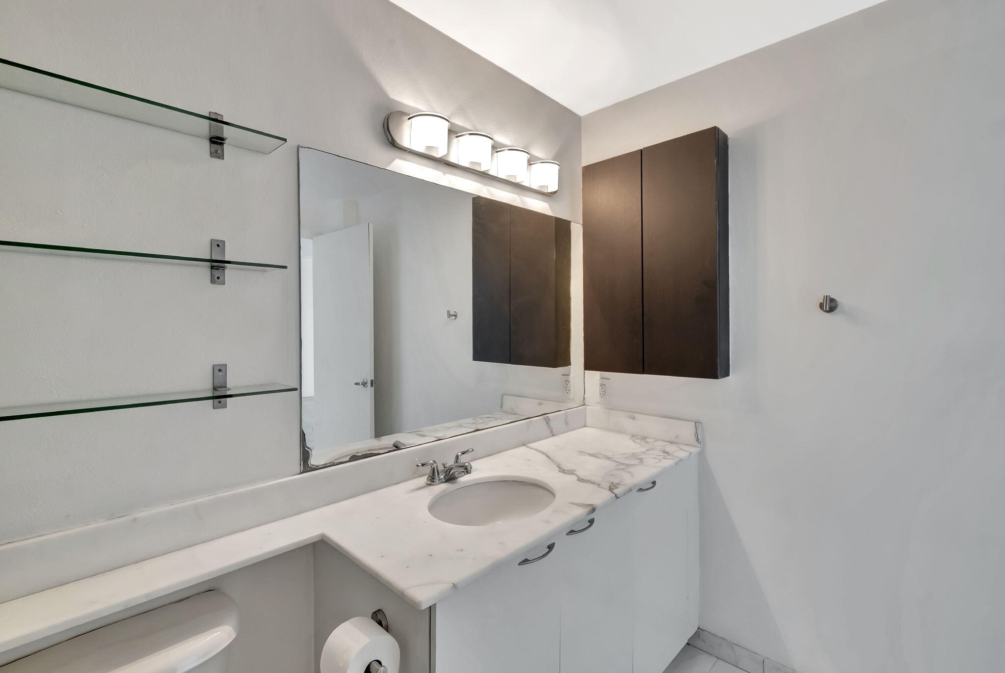 234 Northeast 3rd Street, Unit 2206 Miami, FL 33132 - Photo 15 of 30 a bathroom with a sink and a mirror