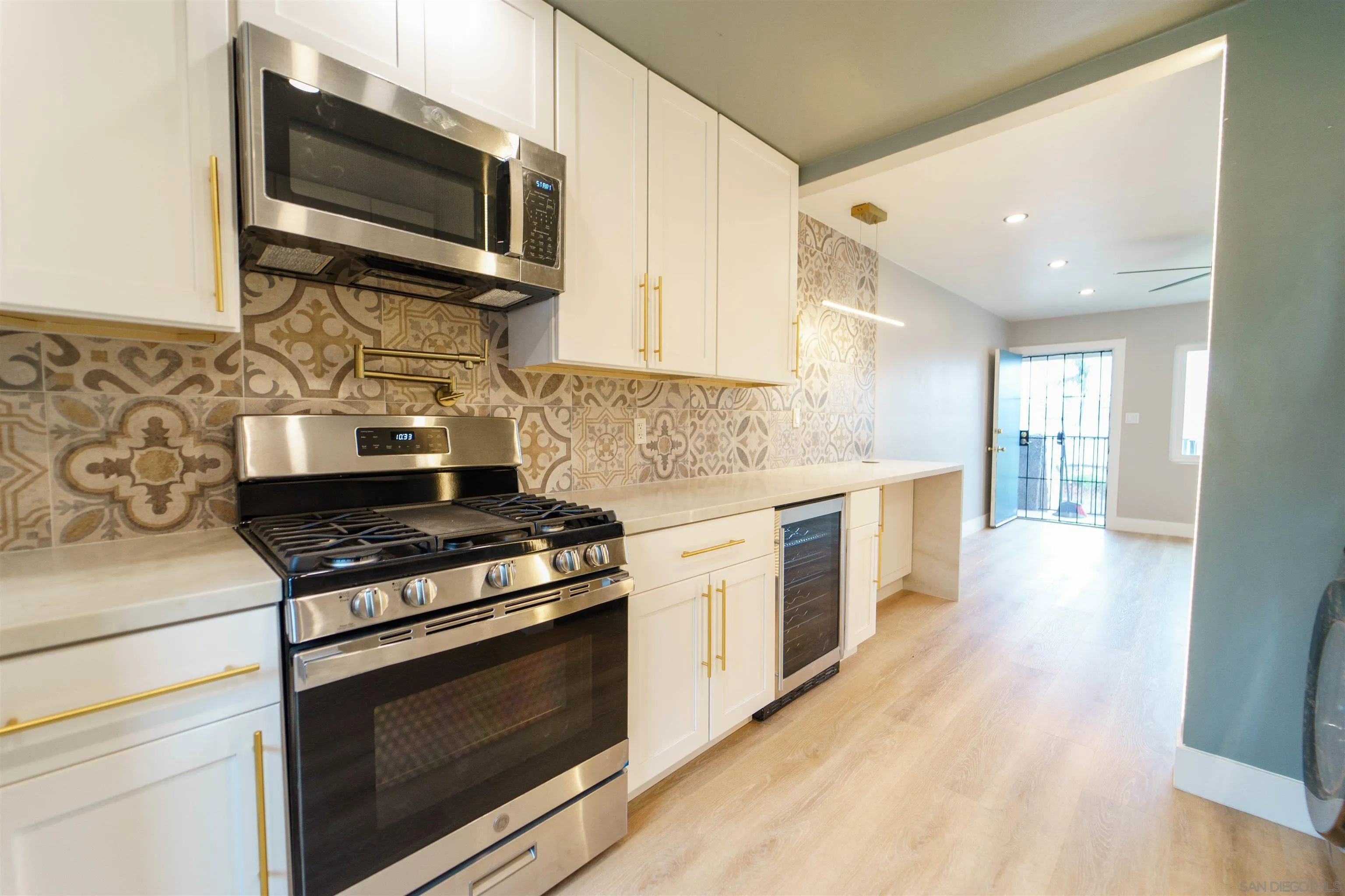 4518-24 Kansas Street San Diego, CA 92116 - Photo 16 of 33 a kitchen with stainless steel appliances a stove microwave and cabinets
